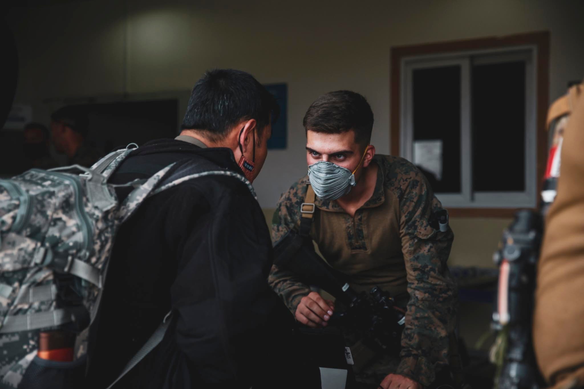 A Marine assigned to the 24th Marine Expeditionary Unit (MEU) processes an evacuee at Hamid Karzai International Airport, Kabul, Afghanistan, August 15. U.S. Soldiers and Marines are assisting the Department of State with an orderly drawdown of designated personnel in Afghanistan. (U.S. Marine Corps photo by Sgt. Isaiah Campbell)