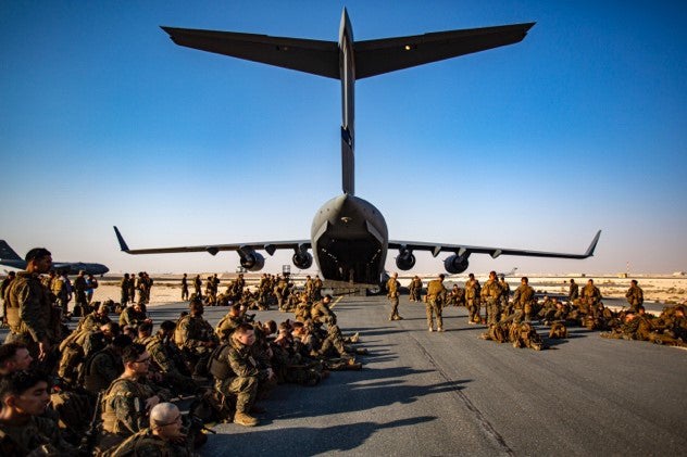 Marines assigned to the 24th Marine Expeditionary Unit (MEU) await a flight at Al Udeied Air Base, Qatar August 17. Marines are assisting the Department of State with an orderly drawdown of designated personnel in Afghanistan. (U.S. Marine Corps photo by 1st Lt. Mark Andries)