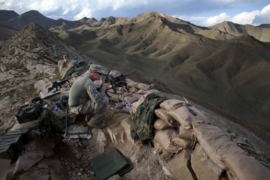 TANGI VALLEY, AFGHANISTAN - MAY 5:   A US soldier with the 3rd Brigade, 10th Mountain Division mans an observation post May 5, 2009 in the Tangi Valley, Wardak Province, Afghanistan.  The 10th Mountain Division, based at Fort Drum in New York, was one of the first units to arrive in Afghanistan for the "surge" in 2009.  Wardak Province, situated just southwest of Kabul, is one of the more active regions for insurgent activity.  (Photo by Jonathan Saruk/Getty Images)