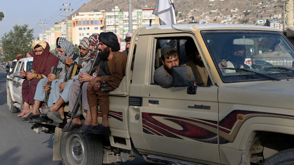 Taliban fighters in a vehicle patrol the streets of Kabul on August 23, 2021 as in the capital, the Taliban have enforced some sense of calm in a city long marred by violent crime, with their armed forces patrolling the streets and manning checkpoints. (Photo by Wakil KOHSAR / AFP) (Photo by WAKIL KOHSAR/AFP via Getty Images)