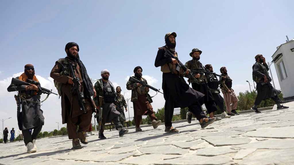 FILE - In this Aug. 19, 2021, file photo, Taliban fighters patrol in Kabul, Afghanistan. After the Taliban takeover, employees of the collapsed government, civil society activists and women are among the at-risk Afghans who have gone into hiding or are staying off the streets. (AP Photo/Rahmat Gul, File)