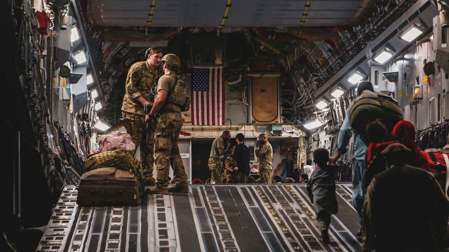 Evacuees board a Boeing C-17 Globemaster III during an evacuation at Hamid Karzai International Airport, Kabul, Afghanistan, Aug. 23. U.S. service members are assisting the Department of State with a Non-combatant Evacuation Operation (NEO) in Afghanistan. (U.S. Marine Corps photo by Sgt. Isaiah Campbell)