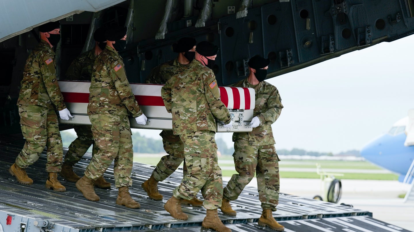 An Army carry team moves a transfer case containing the remains of Army Staff Sgt. Ryan C. Knauss, 23, of Corryton, Tenn., Sunday, Aug. 29, 2021, at Dover Air Force Base, Del. (AP Photo/Manuel Balce Ceneta)