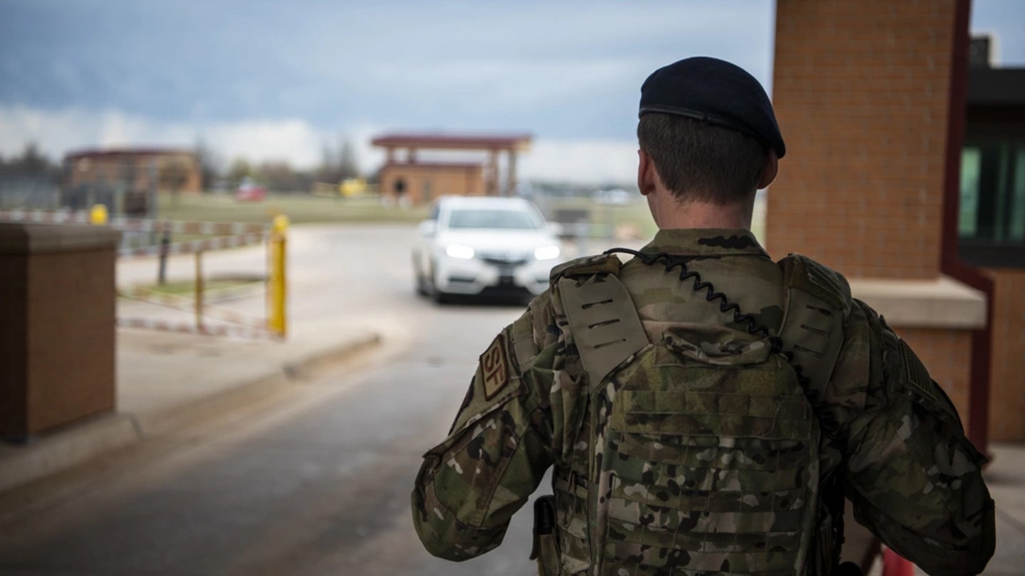 U.S. Air Force Airman 1st Class Mason Bright, an entry controller assigned to the 71st Security Forces Squadron, stands ready at the main gate March 30, 2020, on Vance Air Force Base, Oklahoma. (U.S. Air Force photo by Senior Airman Taylor Crul)