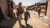 In this image provided by the U.S. Marine Corps, a U.S. Marine with the Special Purpose Marine Air-Ground Task Force-Crisis Response-Central Command escorts a child during ongoing evacuations at Hamid Karzai International Airport, Kabul, Afghanistan, Tuesday, Aug. 24, 2021. (Staff Sgt. Victor Mancilla/U.S. Marine Corps via AP)