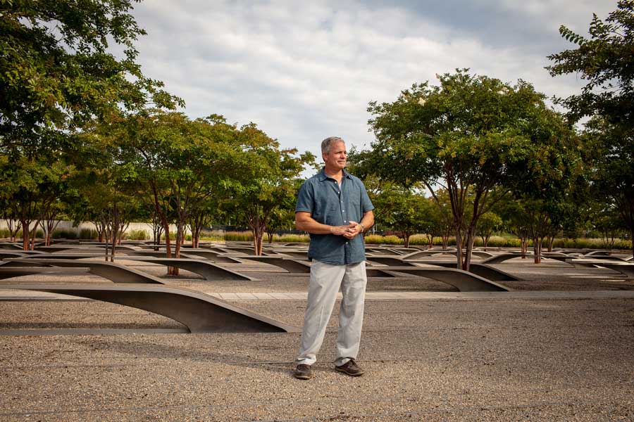 Robert Hogue stands at the center of the Pentagon 9/11 Memorial in Arlington, Virginia. (Photo by Eliot Dudik, for The War Horse.)