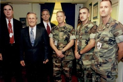 Robert Hogue and Peter Murphy stand with former Secretary of Defense Donald Rumsfeld. (Photo courtesy of Robert Hogue.)
