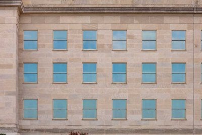 Windows at the Pentagon reflect a cloudy August morning. (Photo by Eliot Dudik, for The War Horse.)