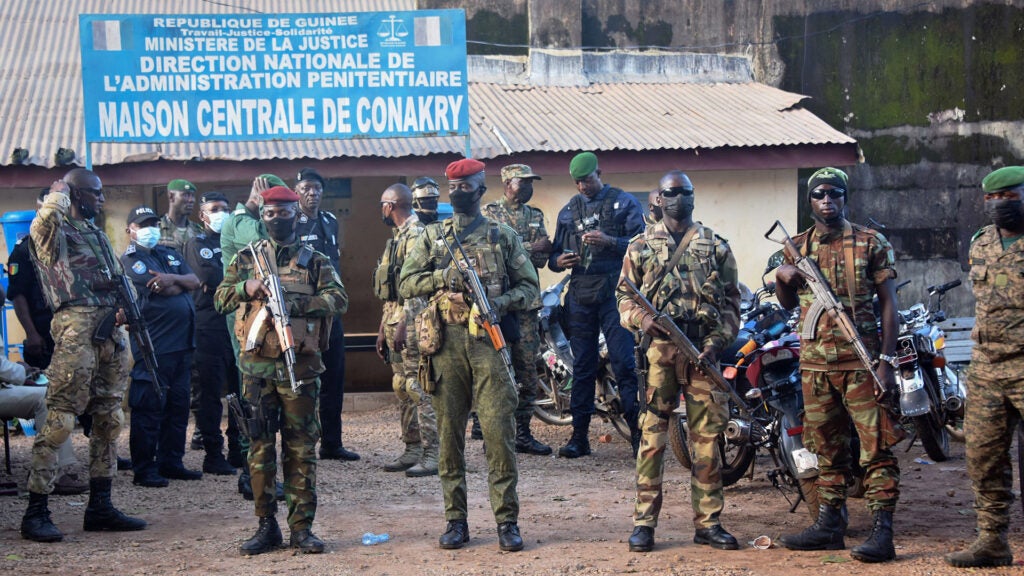 Soldiers of Guinea's special forces stand in front of the Central Prison in Conakry on September 7, 2021, ahead of the release of dozens of political opponents of the deposed president. - Putschists in Guinea released a group of political opponents of deposed president Alpha Conde on September 7, as the regional bloc ECOWAS prepared to discuss the turmoil in the West African nation. Special forces led by Lieutenant Colonel Mamady Doumbouya staged a coup in the mineral-rich but impoverished country on Sunday and arrested the president, sparking international condemnation. (Photo by CELLOU BINANI / AFP) (Photo by CELLOU BINANI/AFP via Getty Images)