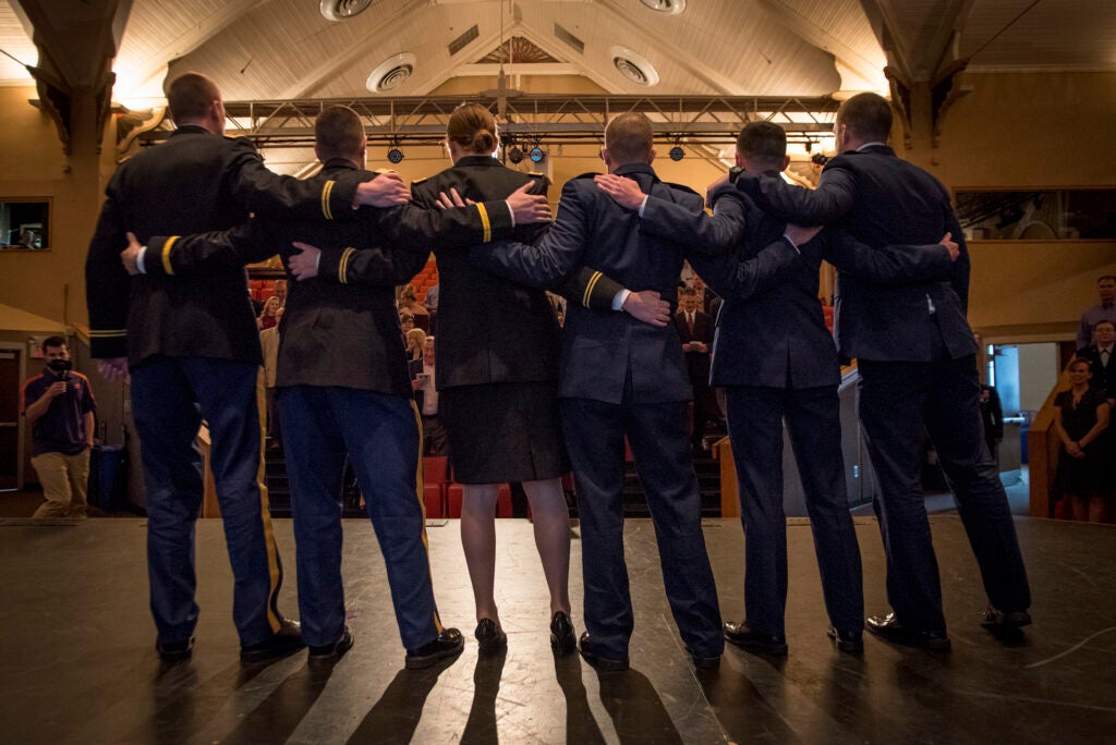 Six new Army and Air Force second lieutenants (three of each) embrace and sing the Army and Air Force songs after being commissioned in a ceremony at Clemson University, Dec. 20, 2017. Clemson's Army and Air Force Reserve Officer's Training Corps units held a joint commissioning ceremony in the Tillman Hall auditorium. U.S. Army Brig. Gen. Stephen B. Owens, director of the joint staff, South Carolina National Guard, was the featured speaker. (Photo by Ken Scar)