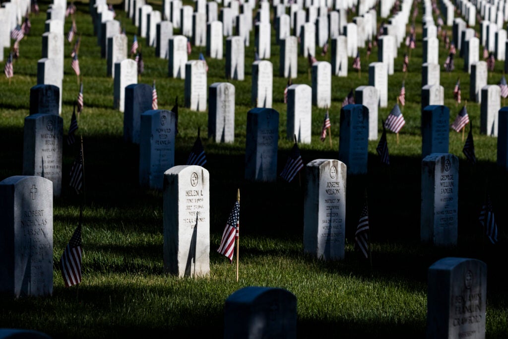 WASHINGTON, DC - MAY 31: American flags have been placed next to the headstones in Arlington National Cemetery in observance of Memorial Day on May 31, 2021 in Arlington, Virginia. (Photo by Samuel Corum/Getty Images)