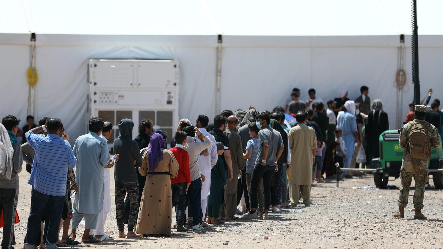 Afghan evacuees form a line at one of the dining facilities at Fort Bliss’ Doña Ana Complex in New Mexico, Sept. 3, 2021. (U.S. Army photo by Pfc. Maxwell Bass, 24th Theater Public Affairs Support Element)