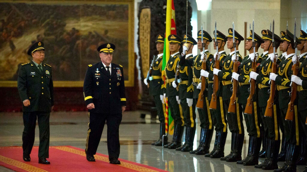 China's People's Liberation Army (PLA) Gen. Li Zuocheng, left, and U.S. Army Chief of Staff Gen. Mark Milley, center, review an honor guard during a welcome ceremony at the Bayi Building in Beijing, Tuesday, Aug. 16, 2016. (AP Photo/Mark Schiefelbein, Pool)
