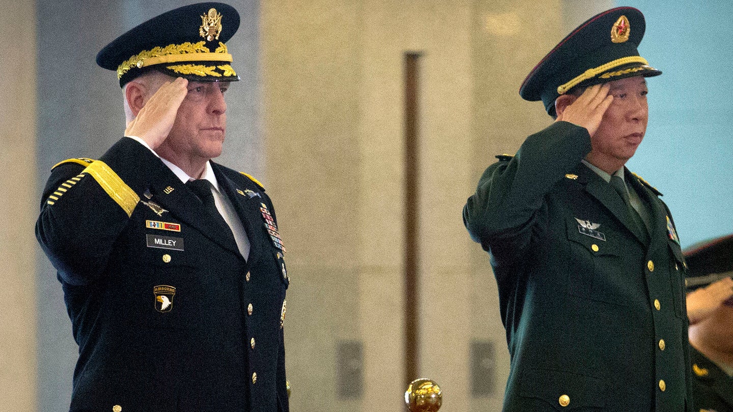 Gen. Mark Milley, then Army chief of staff, and China's People's Liberation Army (PLA) Gen. Li Zuocheng, salute during a welcome ceremony at the Bayi Building in Beijing, Tuesday, Aug. 16, 2016. (AP Photo/Mark Schiefelbein, Pool)