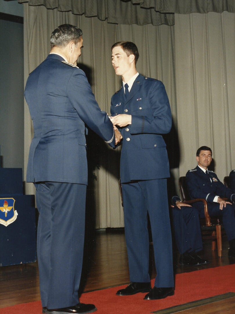 U.S. Air Force 2nd Lt. John Marks, now a Lt. Col., shakes hands with an Air Force official during his graduation from Officer Training School in 1987. Marks attended undergraduate pilot training at Columbus Air Force Base, Mississippi, shortly after his OTS graduation. (Courtesy photo provided by Mary Marks)