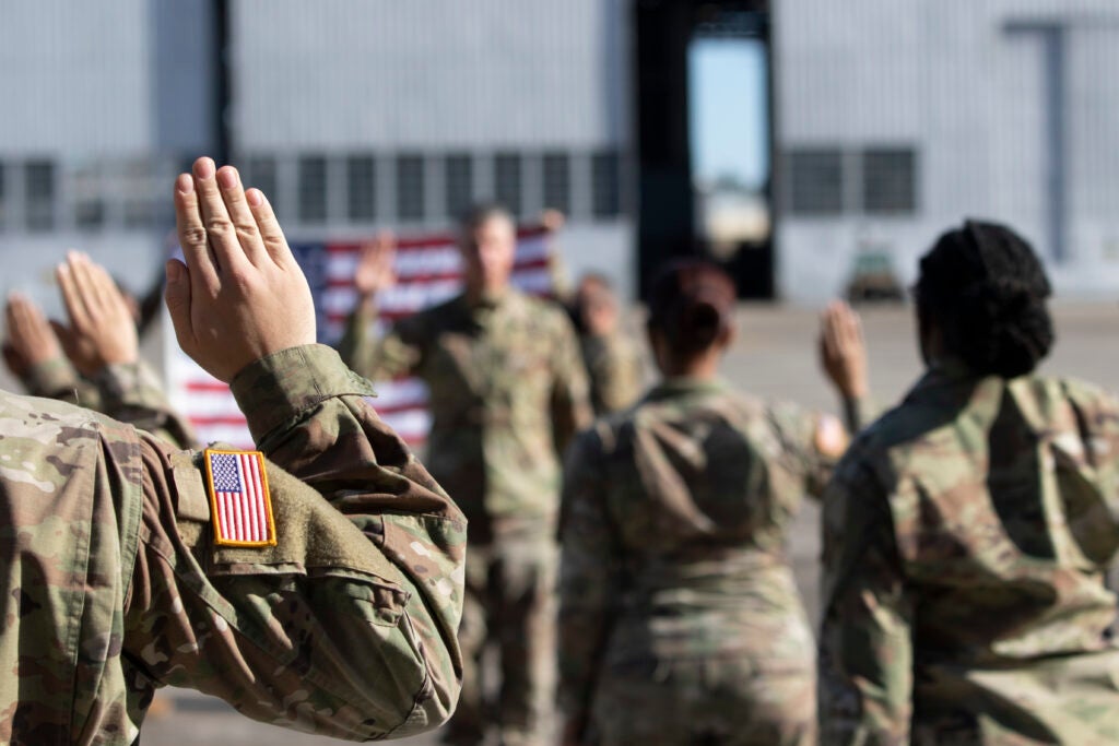 Soldiers raise their right hands and volunteer to continue their Army service on Hunter Army Airfield, Georgia, March 10.