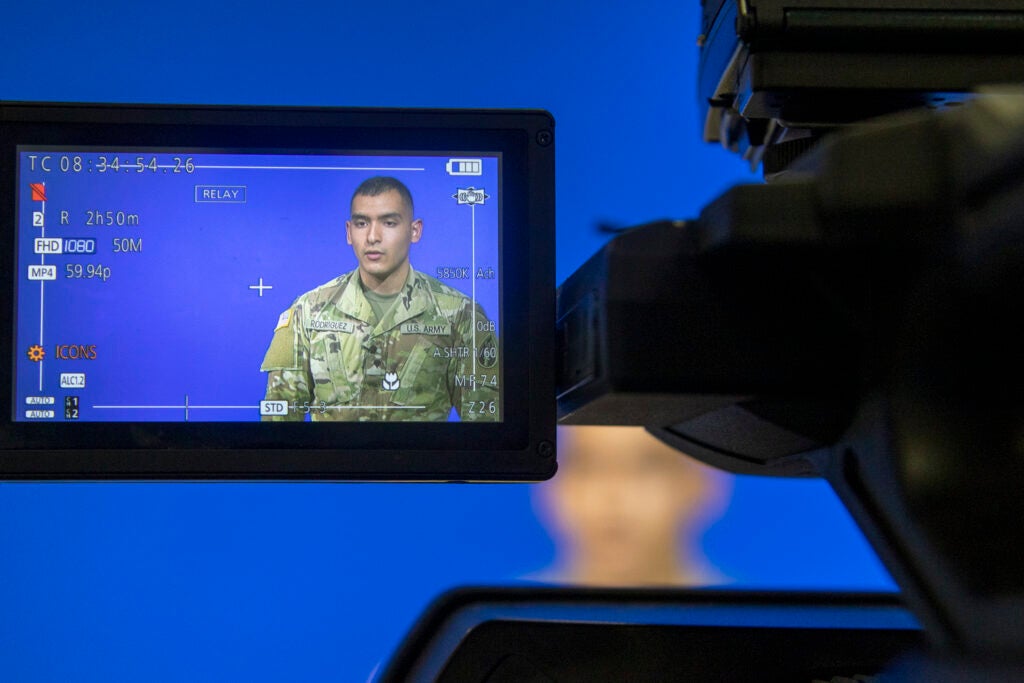 Spc. Antonio Rodriguez, a public affairs mass media communication specialist with the 206th Broadcast Operations Detachment, 205th Theater Public Affairs Support Element, 63rd Readiness Division – Mission Command Support Group, records a television broadcast as part of Operation News Day Aug. 17, 2021, on Fort McCoy, Wis. The 206th BOD conducted their annual training on Fort McCoy. (U.S. Army photo by Staff Sgt. Ryan Rayno)