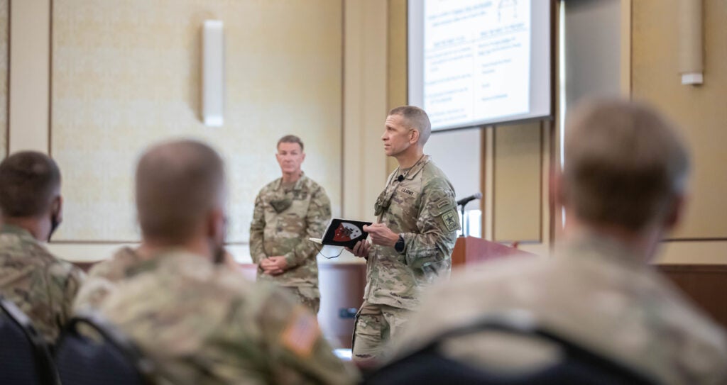 U.S. Army Gen. James C. McConville (center left), Chief of Staff of the Army, and Sgt. Maj. of the Army Michael Grinston (center right) speak with senior leadership on Fort Bragg, North Carolina, Sept. 1, 2021. The purpose of the visit was brief senior leaders across Fort Bragg and to meet with spouses of Paratroopers. (U.S. Army photo by Spc. Jacob Moir)