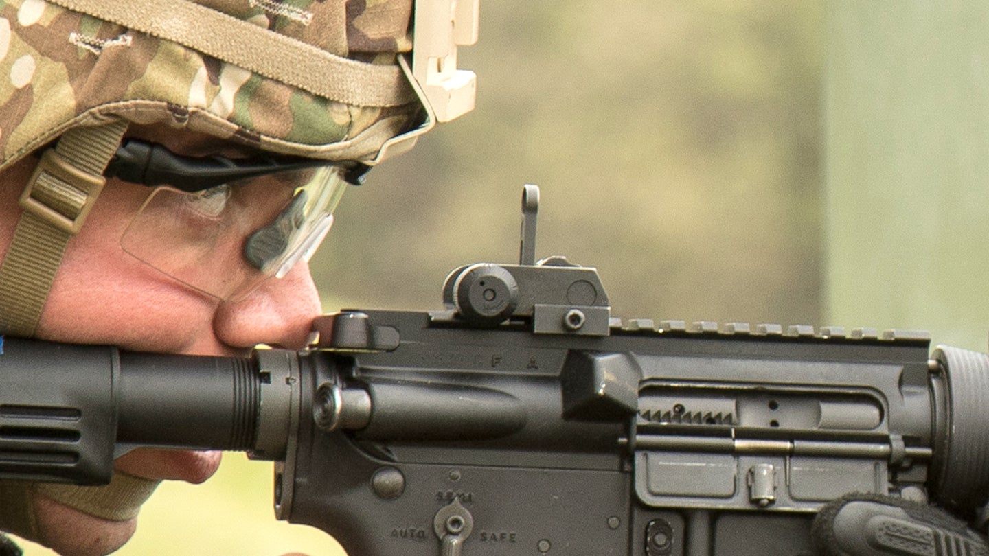 Sgt. Angel Cardona, a U.S. Army Reserve Soldier from the 1st Mission Support Command, peers through the rear iron sight of his M4A1 Carbine at the M4 Qualification event during the 2021 U.S. Army Reserve Best Warrior/Best Squad Competition at Fort McCoy, Wis., May 21., 2021.