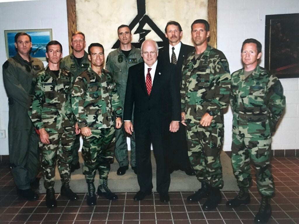 Joe O'Keefe and other service members take a photo with Vice President Dick Cheney. O'Keefe is standing in the back row wearing a suit and tie. (Photo courtesy Joe O'Keefe)