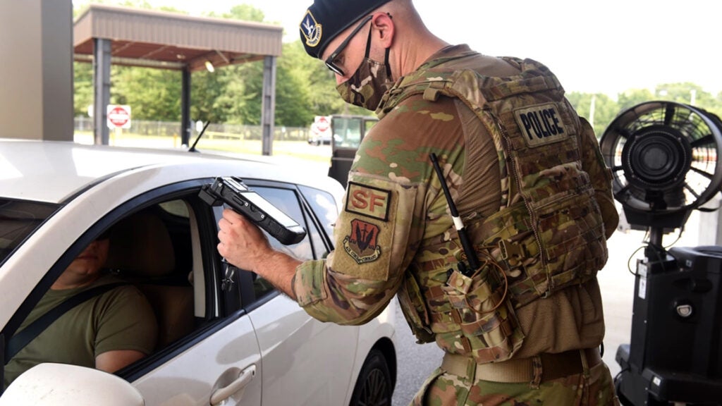 U.S. Air Force Senior Airman Aaron Butler, 169th Security Forces Squadron installation controller, confirms identification of personnel entering the front gate at McEntire Joint National Guard Base, South Carolina, Aug. 10, 2021. (U.S. Air National Guard photo by Senior Airman Mackenzie Bacalzo, 169th Public Affairs)