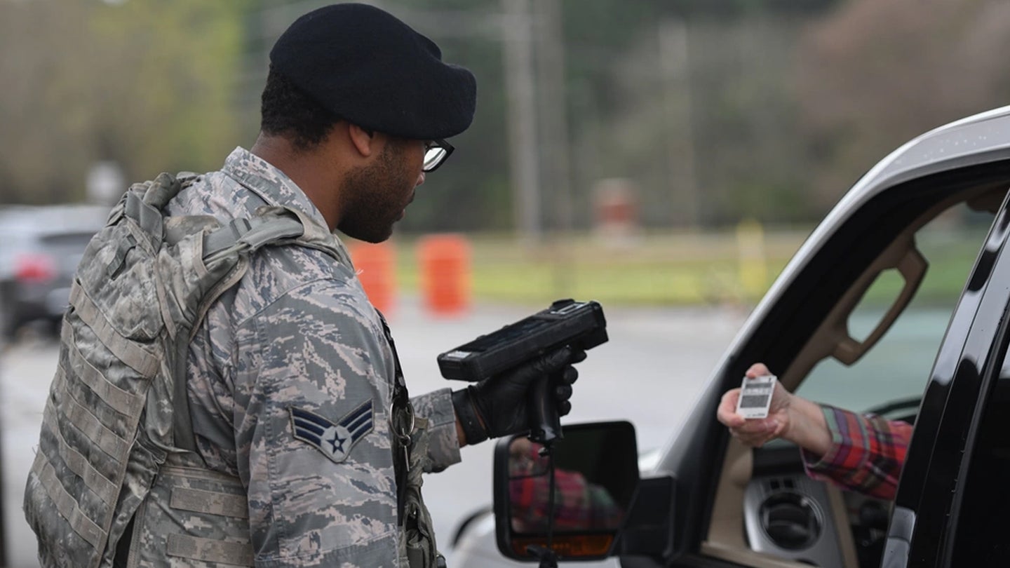 U.S. Air Force Senior Airman Jerrold Manago, 19th Security Forces Squadron installation entry controller, checks an I.D. under new procedures at Little Rock Air Force Base, Arkansas, March 20, 2020. (U.S. Air Force photo by Airman 1st Class Jayden Ford)