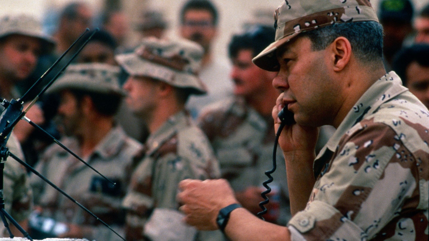 Then-Gen. Colin Powell, the chairman of the Joint Chiefs of Staff, talks on a field phone during a visit with the troops, in Dharan, Saudi Arabia, December 1990. (Photo by Department of Defense/Mark Reinstein/Corbis via Getty Images)