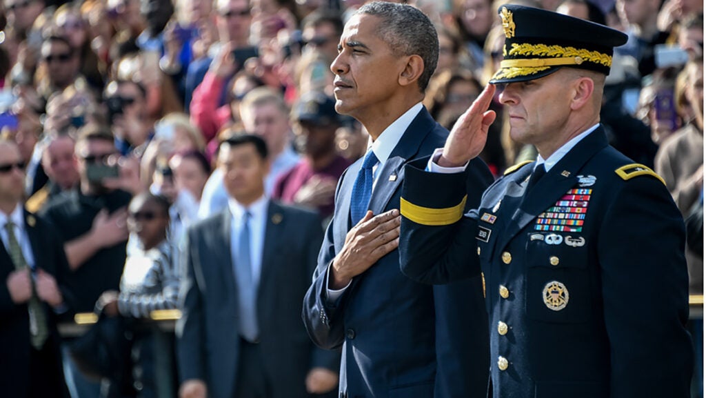President Barack Obama and Maj. Gen. Bradley A. Becker, Commanding General U.S. Army Military District Of Washington pay their respects after placing a wreath at the Tomb of the Unknown Soldier in observance of Veterans Day, in Arlington National Cemetery, Arlington, Va., Nov. 11, 2016.  (U.S. Army photo by Sgt. Alicia Brand/Released)