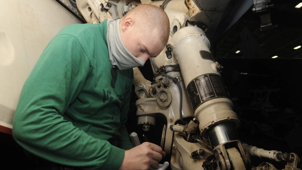 PACIFIC OCEAN (August 4, 2020) Aviation Structural Mechanic 3rd Class Phillip Weilacher, from Houston, writes notes about an inspection of the landing gear of an F/A-18E Super Hornet, assigned to the “Dambusters” of Strike Fighter Squadron (VFA) 195, checking for corrosion and damage. (Navy photo by Mass Communication Specialist Seaman Askia Collins)