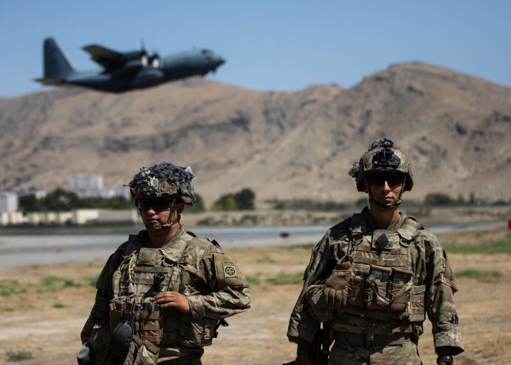 Two Paratroopers assigned to the 1st Brigade Combat Team, 82nd Airborne Division conduct security while a C-130 Hercules takes off during a non-combatant evacuation operation in Kabul, Afghanistan, August 25. The Department of Defense is supporting the Department of State in evacuating U.S. civilian personnel, Special Immigrant Visa applicants, and other at-risk individuals from Afghanistan as quickly and safely as possible. (DoD courtesy photo)
