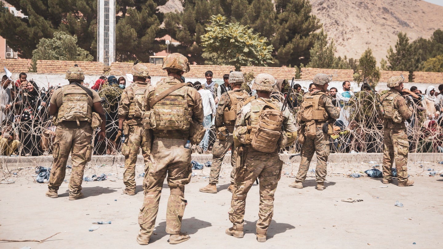 U.S. Army soldiers and Marines assist with security at an Evacuation Control Checkpoint during an evacuation at Hamid Karzai International Airport, August  19, 2021 in Kabul, Afghanistan. (Photo by Staff Sgt. Victor Mancilla / U.S. Marine Corps via Getty Images)
