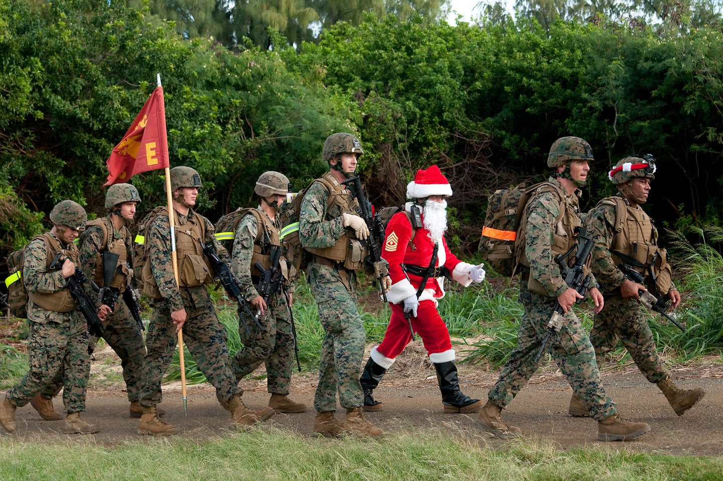 Marines and sailors from 2nd Battalion, 3rd Marine Regiment, enter the Boondocker training area after a 9-mile hike, Dec. 19, 2011.