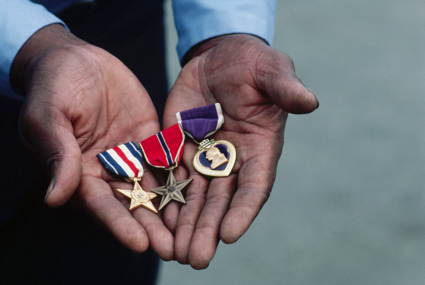 Frank Goins holds his military decorations earned for bravery in combat in Vietnam. The medals, from left to right, are: the Silver Star, the Bronze Star, and the Purple Heart. Goins served in the 1st Infantry Division, C Company, of the United States Army. (Photo by © Wally McNamee/CORBIS/Corbis via Getty Images)