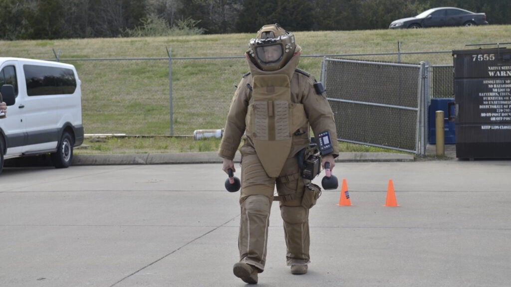 Staff Sergeant Cameron Niccum, 744th Ordnance Company, 184th Ordnance Battalion, 52nd Explosive Ordnance Group (Explosive Ordnance Disposal), tests his strength and mobility April 7 while wearing a Next Generation Advanced Bomb Suit during human factors evaluation, April 7, 2021 (Army photo)