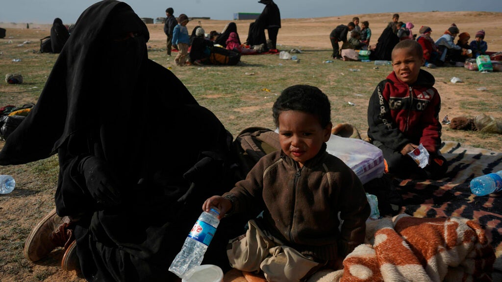 A woman and her children, who were evacuated out of the last territory held by Islamic State sit outside Baghouz, Syria, Tuesday, March 5, 2019. The latest wave of evacuations brings the final defeat of IS by the Kurdish-led Syrian Democratic Forces one step closer — a milestone in the devastating four-year campaign to defeat the group’s so-called “caliphate” that once covered a vast territory straddling both Syria and Iraq.(AP Photo/Andrea Rosa)