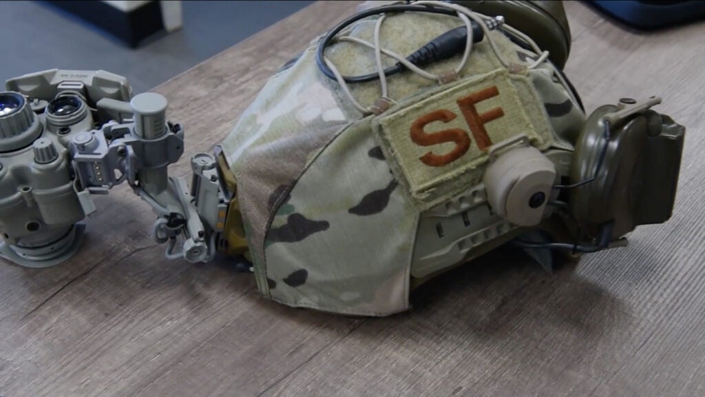 An Air Force security forces helmet equipped with a PSQ-20B enhanced night vision goggle via Master Sgt. Shannon Fulmer's 3D-printed helmet mount spacer. (Screen shot via Air Force video / Airman 1st Class Sophia Robello)
