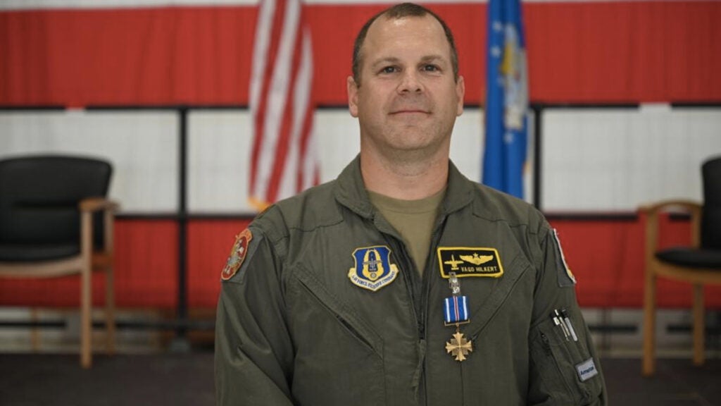 Maj. Mike “Vago” Hilkert, an A-10 Thunderbolt II pilot with the 303rd Fighter Squadron, is awarded the Distinguished Flying Cross Oct. 2, 2021, in the 5-Bay hangar on Whiteman Air Force Base, Mo. Hilkert received the award for actions taken on a combat search and rescue mission in 2011 in the Kapisa province of Afghanistan. (US Air Force photo by Staff Sgt. Kristin Cerri)