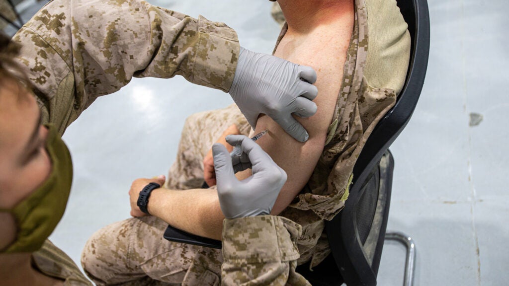FILE PHOTO: A U.S. Marine receives the COVID vaccine in Kuwait, Mar. 16, 2021. (U.S. Marine Corps photo by Lance Cpl. Jacob Yost)