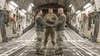 U.S. Air Force Tech. Sgt. Joseph Rice, 436th Aerial Port Squadron ramp operations supervisor, officiates a wedding ceremony for U.S. Airmen in the cargo compartment of a C-17 Globemaster III Jan. 29, 2018, at Dover Air Force Base, Delaware. Rice has been ordained for 10 years, but this was the first wedding he had ever officiated aboard an aircraft. (U.S. Air Force photo by Roland Balik)