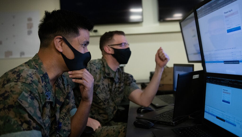 U.S. Marine Corps Gunnery Sgt. Kiriden Benny, left, and Staff Sgt. Travis Nichols, Defensive Cyberspace Operations-Internal Defensive Measures, 6th Communication Battalion, compete to capture flags, earning points based off of varying levels of difficulty during the Marine Corps "Capture the Flag" Cyber Games 2021 at Fort Meade, Maryland, Nov. 5, 2021. 6th Comm Bn. Cyber Team won the competition with 3,300 points, demonstrating a combination of industry and Marine Corps experience as a recipe for success. The competition consisted of eight teams across the Marine Corps including representatives from each Marine Expeditionary Force (MEF), Marine Corps Forces Reserve (MARFORRES) and the Cyber Mission Force (CMF) which encompasses Marine Corps Forces Cyberspace Command (MARFORCYBER), and Marine Corps Cyberspace Warfare Group (MCCYWG). The Deputy Commandant for Information (DC I) hosted the third iteration of the Marine Corps Cyber Games which focused on exercising skills related to offensive cyber operations. (U.S. Marine Corps photo by Lance Cpl. Hailey Music).