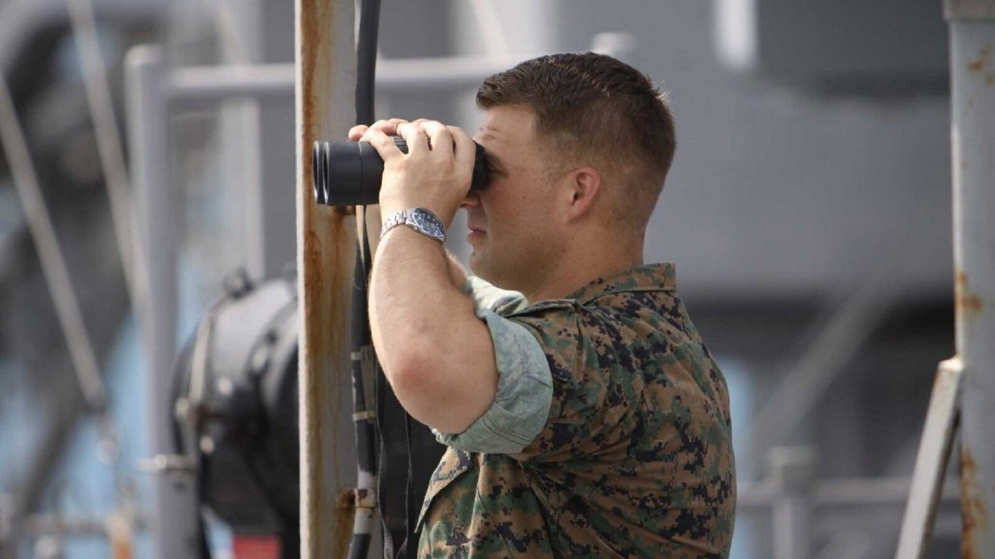Dillon Fishman looks through binoculars aboard the USS Tortuga during amphibious training in southeast Asia when he served as the executive officer of the landing force. (Photo courtesy of the author.)