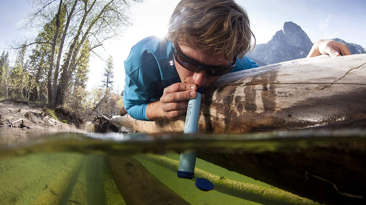 A LifeStraw personal water filter in action.