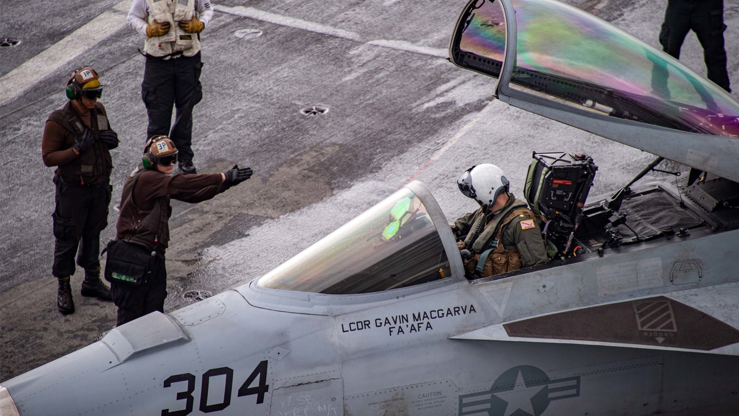 A Sailor directs an F/A-18E Super Hornet, assigned to the “Golden Dragons” of Strike Fighter Squadron (VFA) 192, through preflight checks on the flight deck of Nimitz-class aircraft carrier USS Carl Vinson (CVN 70), Nov. 19, 2021. U.S. forces with 1st Marine Aircraft Wing and the U.S. Navy’s 7th Fleet are conducting a large-scale joint rehearsal of tactics and simulated strikes on naval targets off the coast of Okinawa, Japan. (U.S. Navy/Mass Communication Specialist Seaman Sophia Simons)