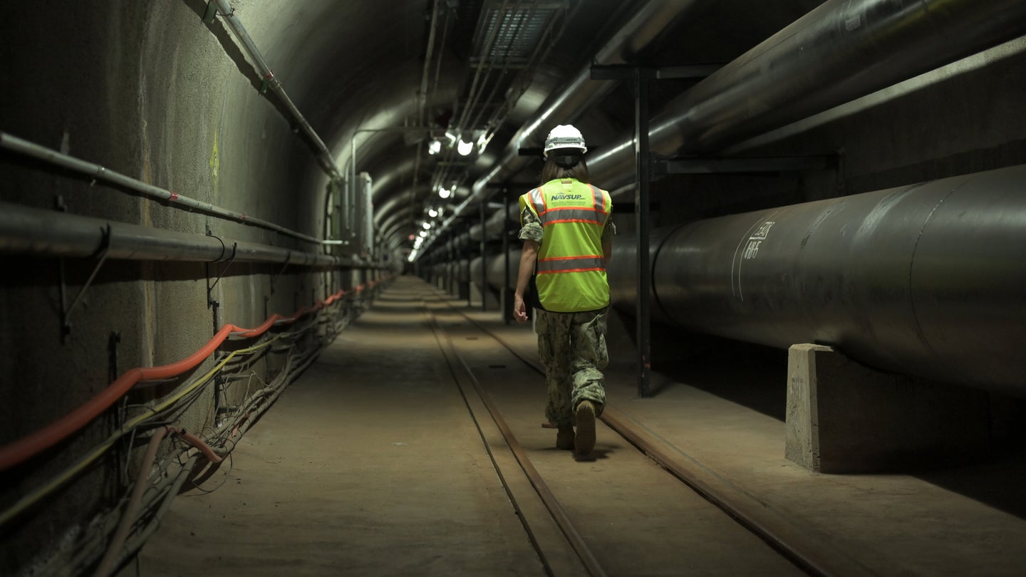 Fuels director, LCDR Shannon Bencs walks a portion of the seven (7) miles of tunnels of the Red Hill Underground Fuel Storage Facility, 2020. (U.S. Navy/Daniel Mayberry/Released)