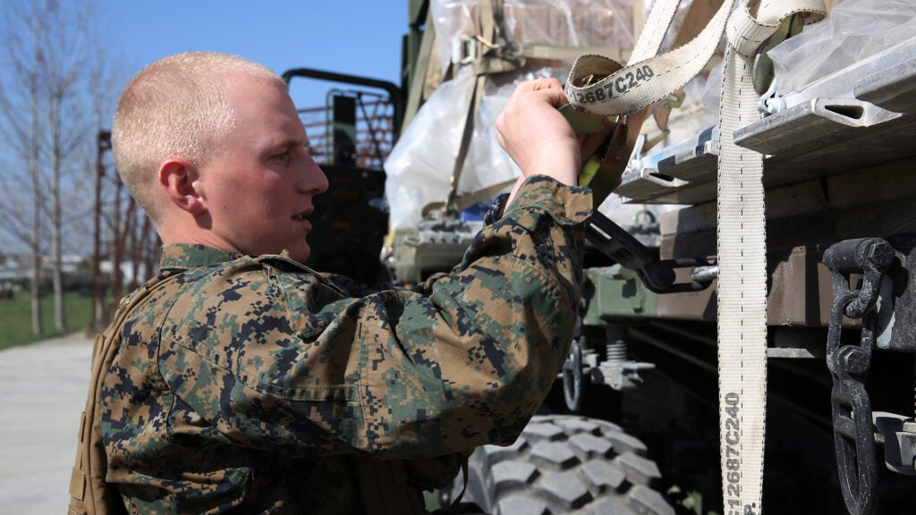 Lance Corporal Nathan Schulz, motor vehicle operator, Logistics Combat Element, 3rd Battalion, 8th Marines, assigned to Black Sea Rotational loosens a strap on a 7-ton truck during a contingency response drill.  Contingency respone drills are designed to train Marines to be ready at a moment’s notice.  Black Sea Rotational Force 14 is a task force of Marines and sailors with the mission to sustain positive relationships with partner nations uphold regional stability and increase military operational capabilities while also proving the ability for rapid crisis response in the Black Sea, Balkan and Caucasus regions of Eastern Europe. (Official Marine Corps photo by Staff Sgt. Tanner M. Iskra, 2nd Marine Division Combat Camera, Black Sea Rotational Force/Released)