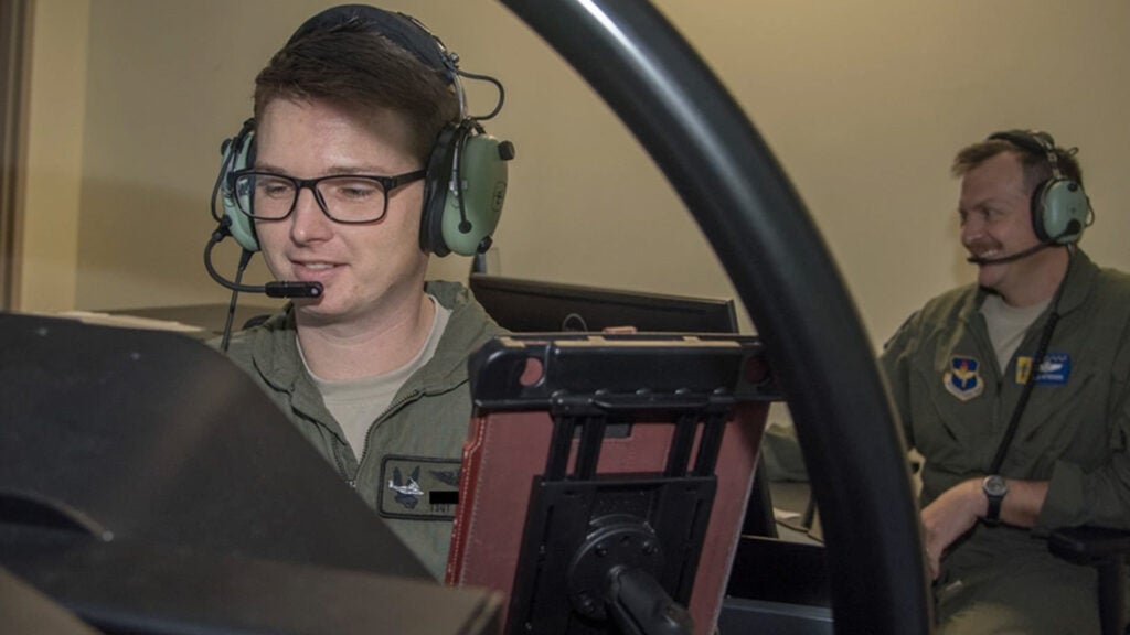 Tech. Sgt. Justin, 558th Flying Training Squadron, remotely piloted aircraft student pilot, prepares to take flight in the T-6 Texan II flight simulator Feb. 5, 2019 at Joint Base San Antonio-Randolph, Texas (U.S. Air Force illustration by Airman 1st Class Shelby L. Pruitt)