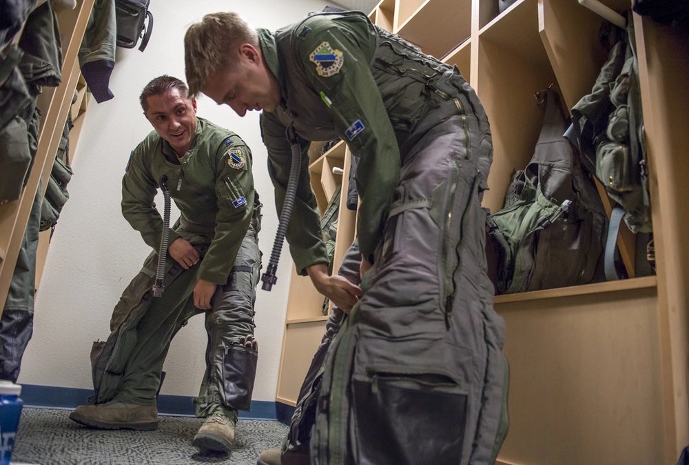 Air Force Capts. Michael Blahut, left, and Brandon Burfeind, F-22 Raptor pilots assigned to the 525th Fighter Squadron, prepare for a sortie on Joint Base Elmendorf-Richardson, Thursday, Oct. 1, 2015. (U.S. Air Force photo/Justin Connaher)