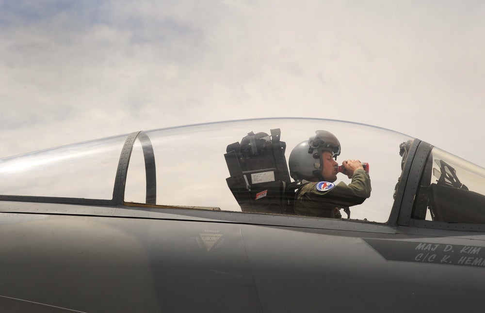Oregon Air National Guard Maj. Jeff Yeates, assigned to the 123rd Fighter Squadron, 142nd Fighter Wing, take a moment to hydrate prior to an afternoon flight in an F-15 Eagle at Nellis Air Force Base, Nev., while supporting the Weapons Instructor Course, June 8, 2017. (U.S. Air National Guard photo by Master Sgt. John Hughel, 142nd Fighter Wing Public Affairs)