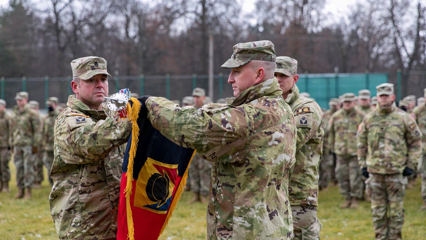 The Florida National Guard’s 53rd Infantry Brigade Combat Team unfurls its colors at a Nov. 30 ceremony in Ukraine. (From Joint Multinational Training Group-Ukraine's Facebook page.)