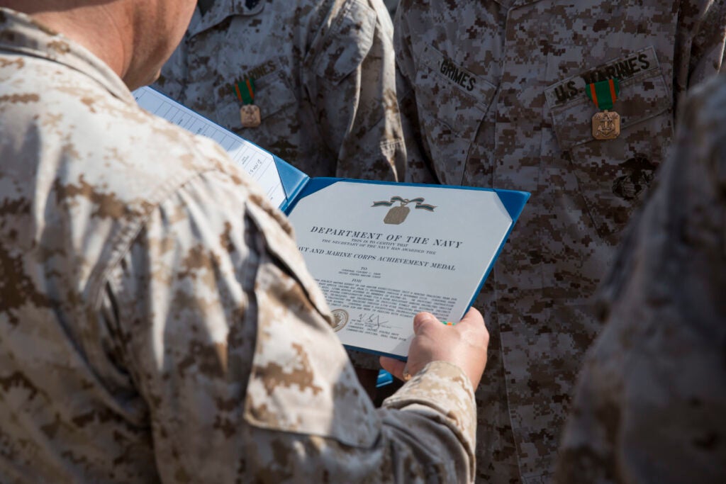 U.S. Marines with Battalion Landing Team 3/1, 13th Marine Expeditionary Unit (MEU), are awarded the Navy and Marine Corps Achievement Medal aboard the San Antonio-class amphibious transport dock USS Anchorage (LPD 23), Jan. 9, 2019. The Essex Amphibious Ready Group and the 13th MEU are deployed to the U.S. 5th fleet area of operations in support of naval operations to ensure maritime stability and security in the Central Region, connecting the Mediterranean and the Pacific through the western Indian Ocean and three strategic choke points. (U.S. Marine Corps photo by Sgt. Austin Mealy/Released)